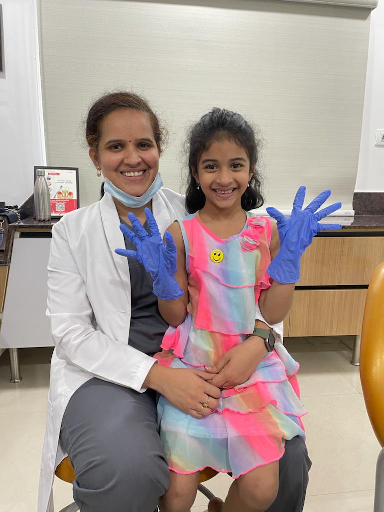 Dr. Sumedha with happy child after pediatric dental visit at Sharanya Dental Clinic Kondapur