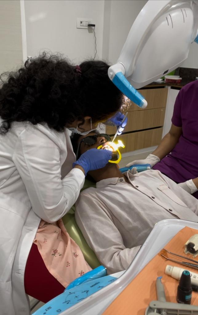 Dr. Sumedha performing restorative dental treatment at Sharanya Dental Clinic, Kondapur Hyderabad