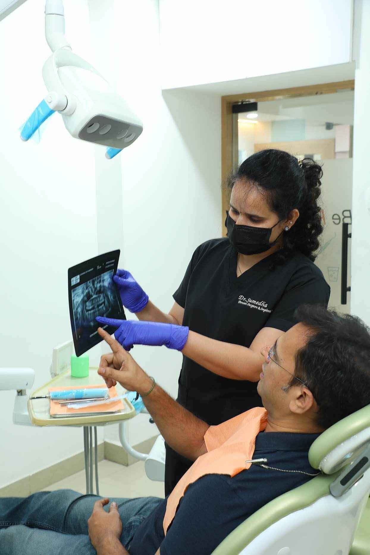 Dr. Sumedha explaining dental X-ray results to a patient at Sharanya Dental Clinic, Kondapur
