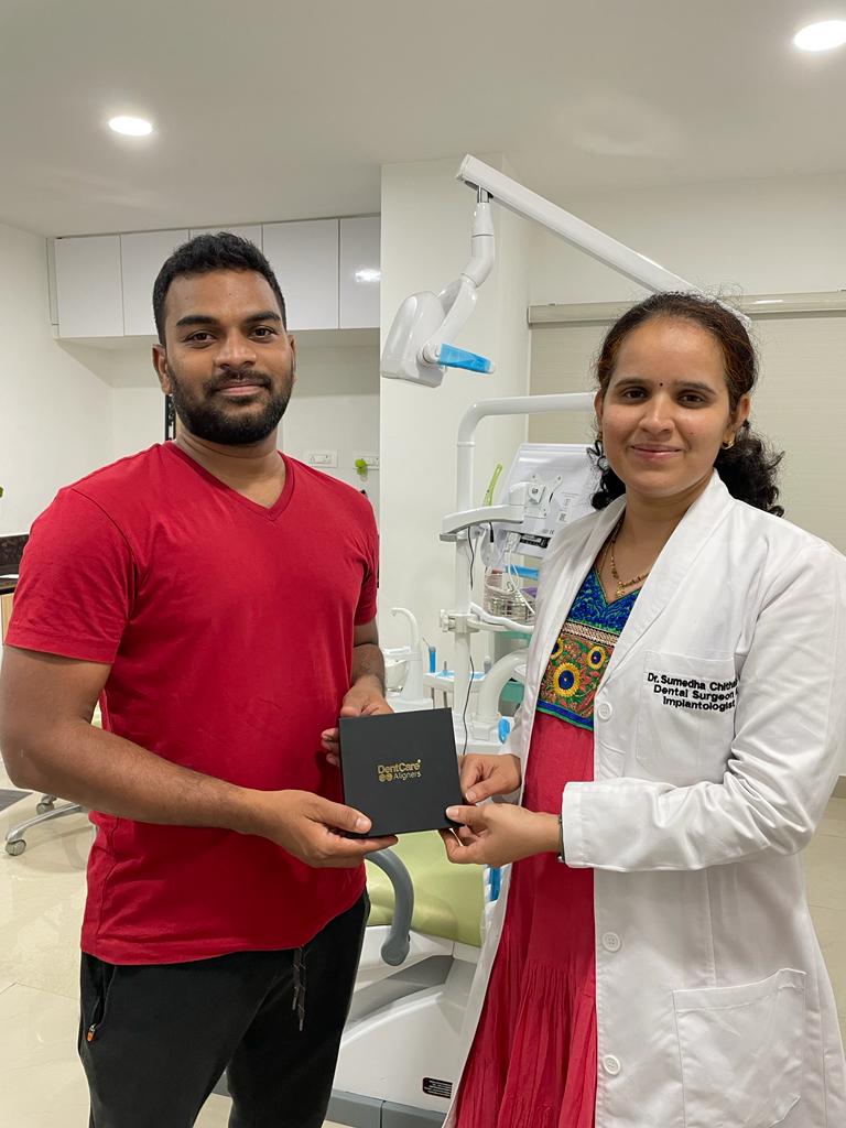 Dr. Sumedha handing over clear aligners pack to patient after consultation at Sharanya Dental Clinic, Kondapur