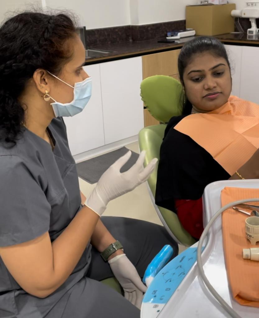Dental consultation between Dr. Sumedha and patient at Sharanya Dental Clinic in Kondapur