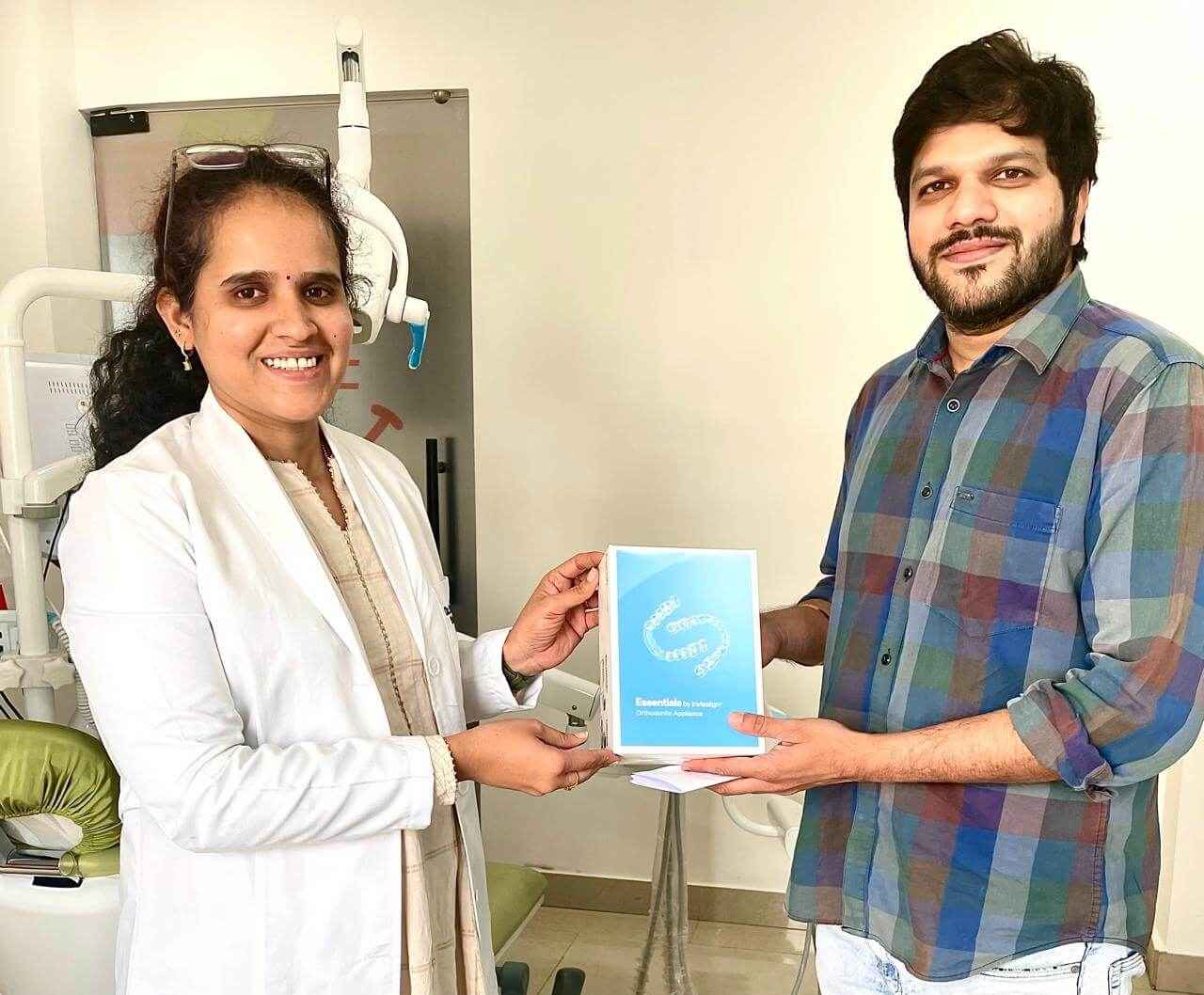 Dr. Sumedha Chithaluru giving Invisalign aligner kit to male patient at Sharanya Dental Clinic, Kondapur Hyderabad